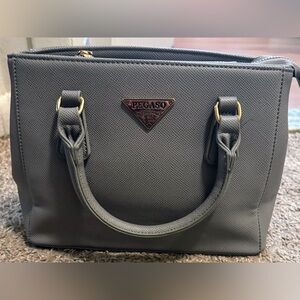 Pegaso brand new condition Grey bag Gold hardware Unsnaps for more room Has feet